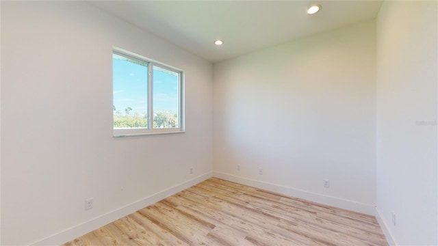 empty room with light hardwood / wood-style flooring