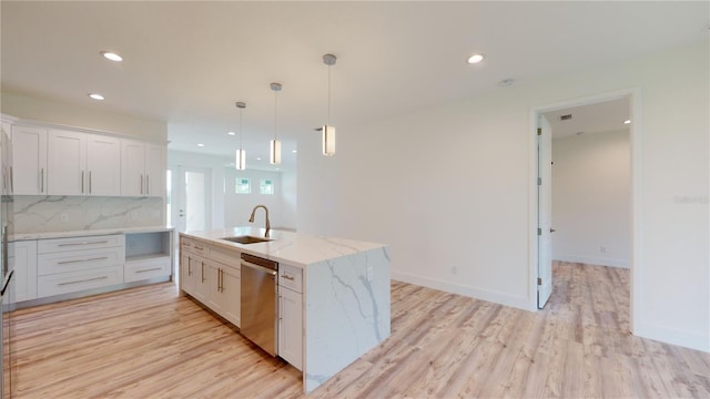 kitchen with stainless steel dishwasher, light hardwood / wood-style floors, a kitchen island with sink, and white cabinetry