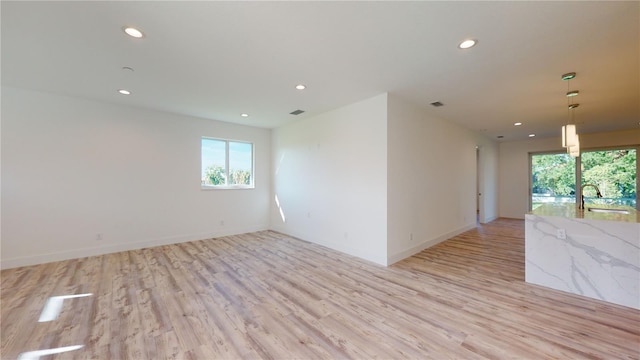 empty room with light hardwood / wood-style flooring and sink