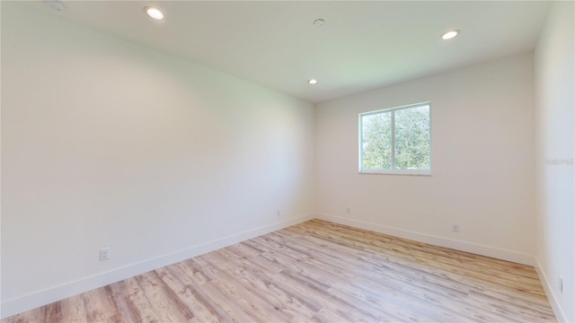 spare room featuring light hardwood / wood-style flooring