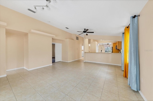 tiled spare room with ceiling fan and track lighting