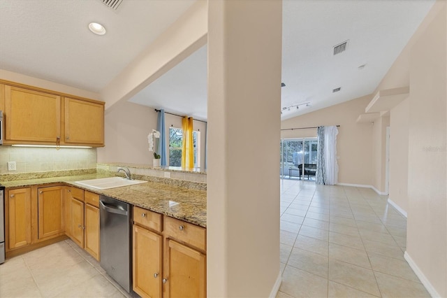 kitchen with light tile floors, light stone countertops, lofted ceiling, dishwasher, and sink