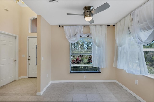 unfurnished room featuring light tile floors and ceiling fan