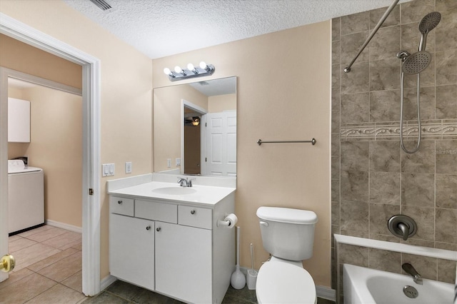 full bathroom featuring toilet, vanity with extensive cabinet space, washer / dryer, tiled shower / bath, and tile flooring