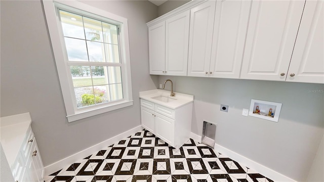 laundry area featuring cabinets, sink, hookup for a washing machine, and hookup for an electric dryer