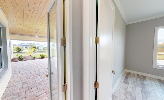 entryway featuring wooden ceiling, crown molding, and light wood-type flooring