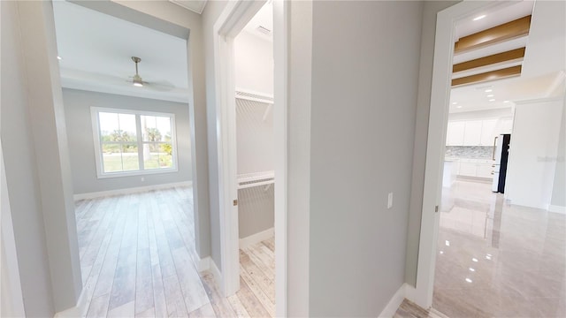 hallway with light hardwood / wood-style floors