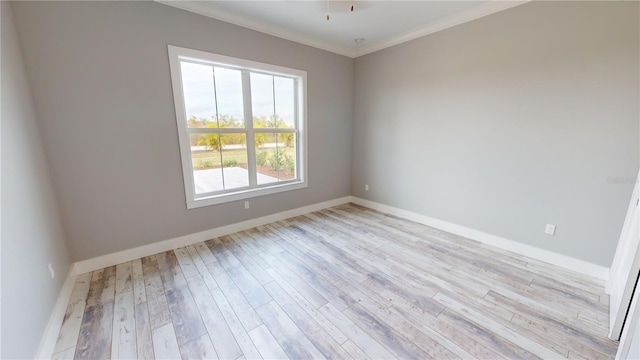 unfurnished room with light wood-type flooring and ornamental molding