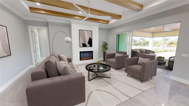 living room featuring ceiling fan, a large fireplace, ornamental molding, and beamed ceiling