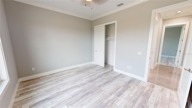 unfurnished bedroom featuring a closet, crown molding, and light hardwood / wood-style floors