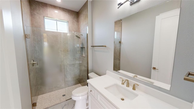 bathroom with toilet, an enclosed shower, and vanity