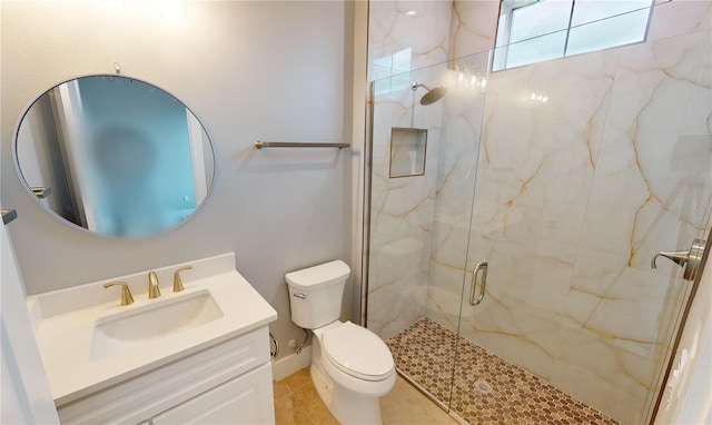 bathroom featuring toilet, vanity, tile patterned floors, and a shower with door