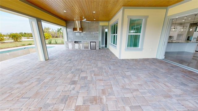 view of patio / terrace with ceiling fan and area for grilling