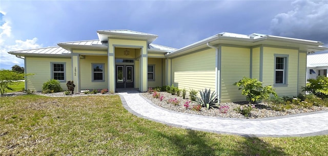 view of front of home with french doors and a front yard