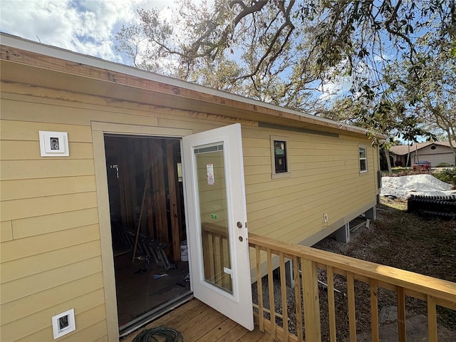 view of exterior entry with a deck