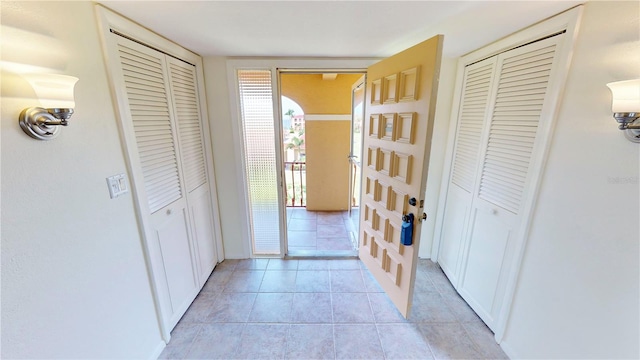 hallway featuring light tile flooring