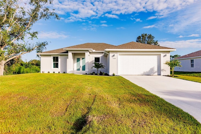 view of front of property with a front lawn and a garage