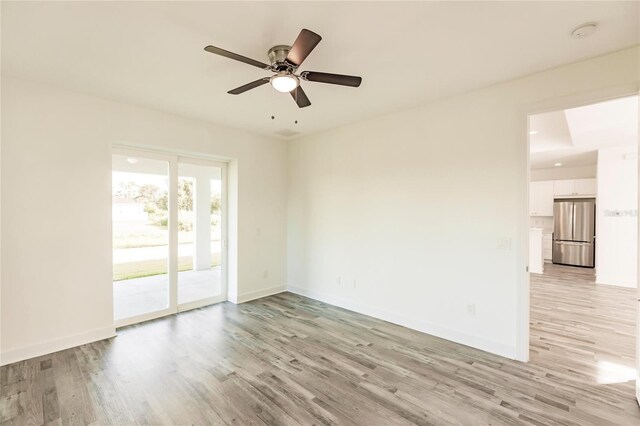 unfurnished room featuring light hardwood / wood-style floors and ceiling fan