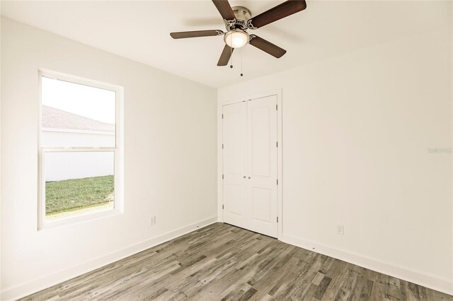 empty room featuring wood-type flooring and ceiling fan