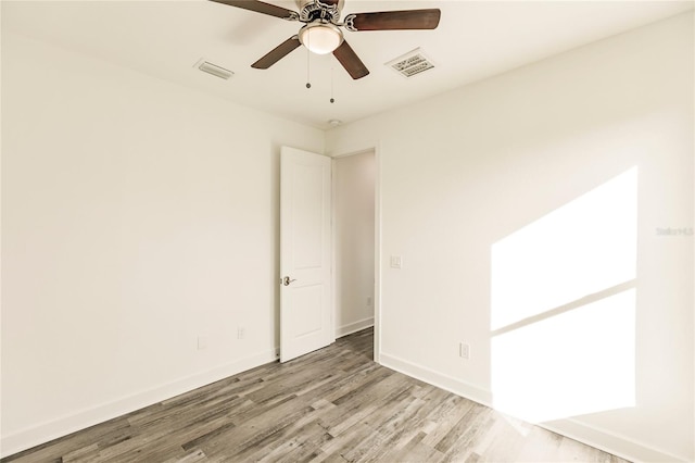 spare room with ceiling fan and light hardwood / wood-style flooring