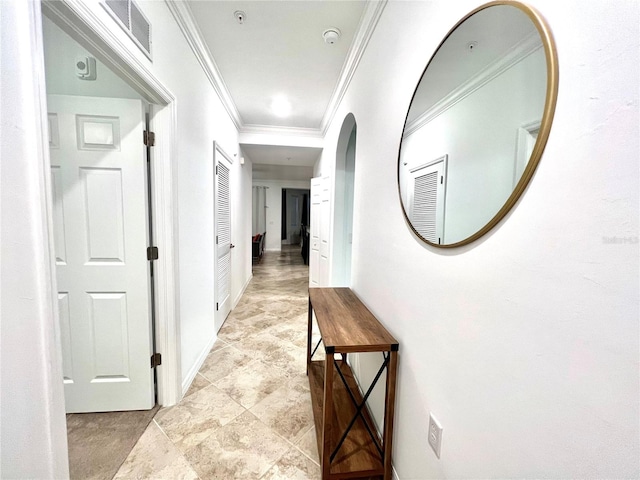 corridor featuring crown molding and light tile flooring