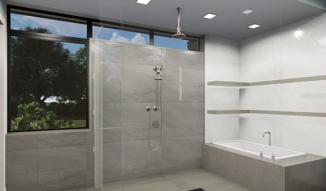 bathroom featuring separate shower and tub