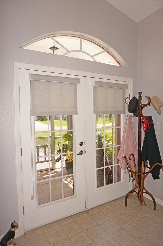 doorway to outside with light tile floors and french doors