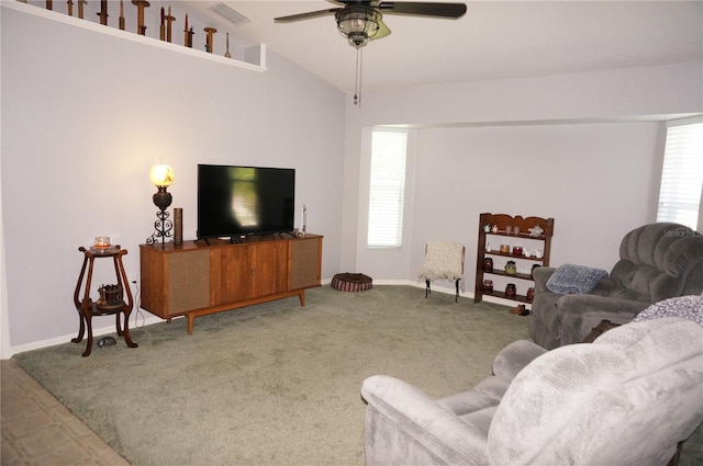 living room with plenty of natural light, vaulted ceiling, ceiling fan, and carpet floors