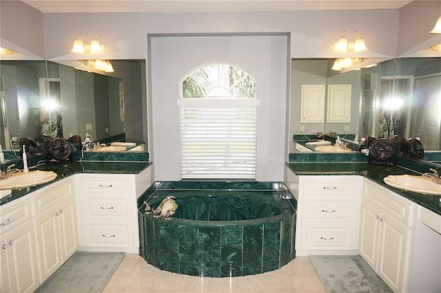 bathroom with a washtub, tile flooring, and double vanity