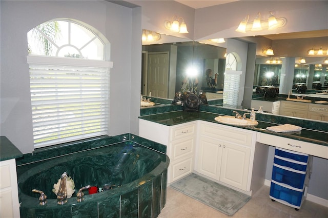 bathroom featuring vanity, tile flooring, a tub, and a wealth of natural light