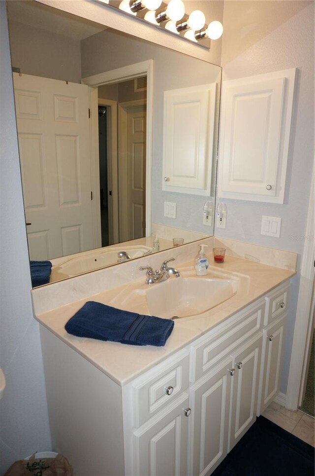 bathroom featuring vanity and tile floors