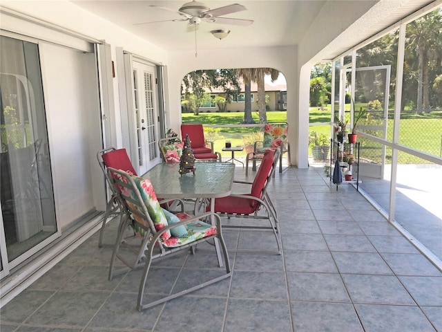 sunroom / solarium with ceiling fan and french doors