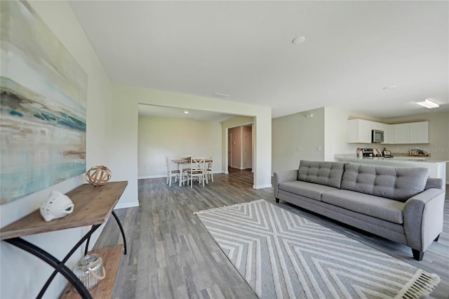 living room with light wood finished floors and baseboards