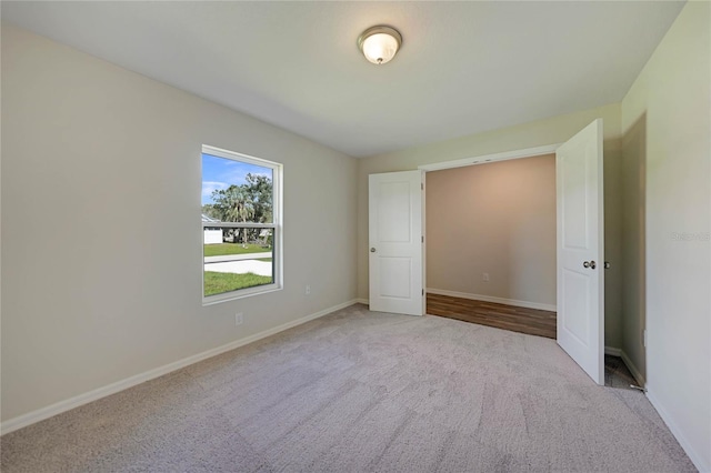 unfurnished bedroom featuring light colored carpet