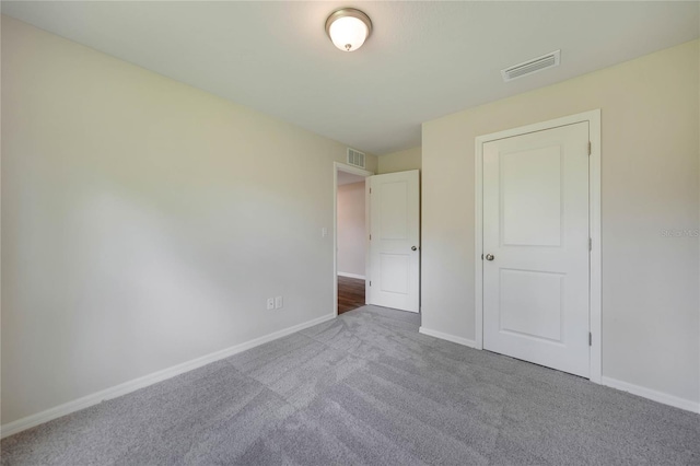 unfurnished bedroom featuring dark carpet