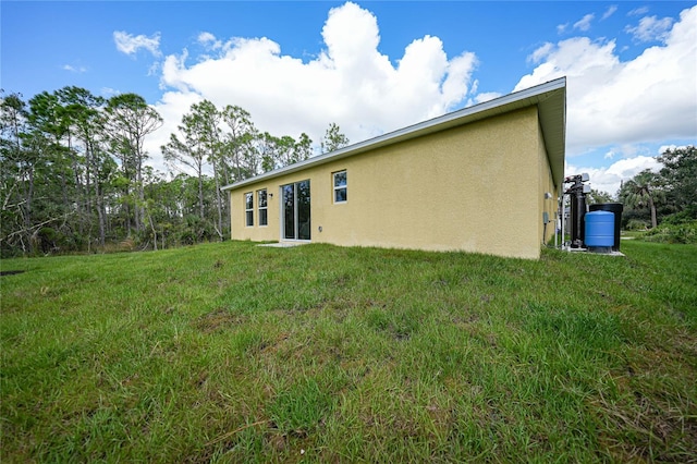 rear view of house featuring a yard