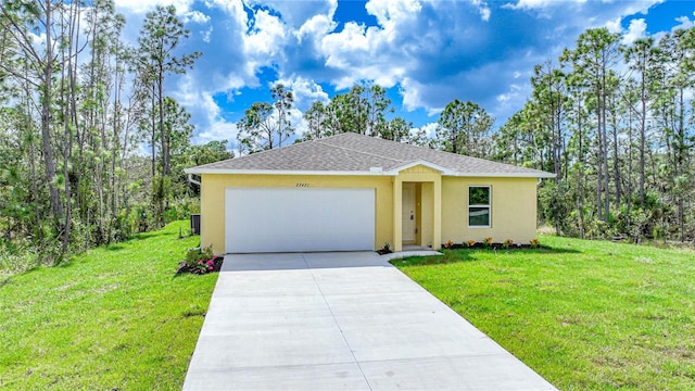 single story home with concrete driveway, a front yard, and stucco siding