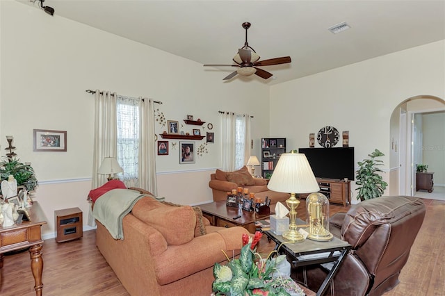 living room featuring ceiling fan and light hardwood / wood-style flooring