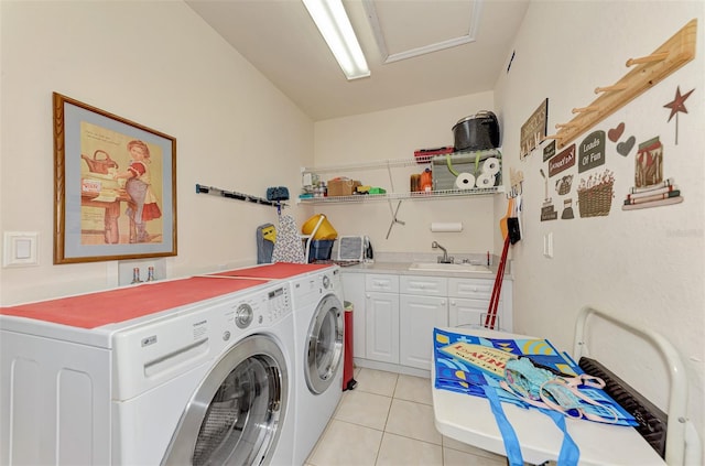 washroom featuring light tile floors, cabinets, washer and dryer, and sink