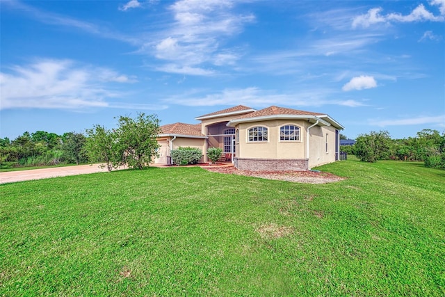 mediterranean / spanish house featuring a front lawn