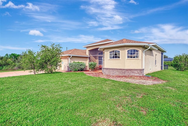 mediterranean / spanish-style home with a front lawn