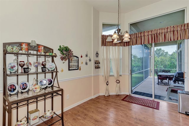 interior space featuring an inviting chandelier and light wood-type flooring