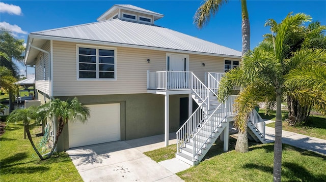 coastal inspired home with a front lawn and a garage