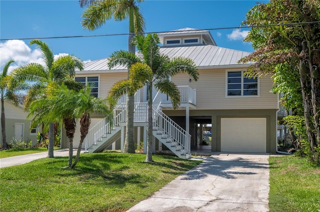 coastal home with a front yard and a garage