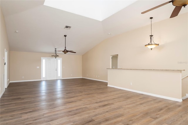 unfurnished living room with lofted ceiling, ceiling fan, and hardwood / wood-style flooring