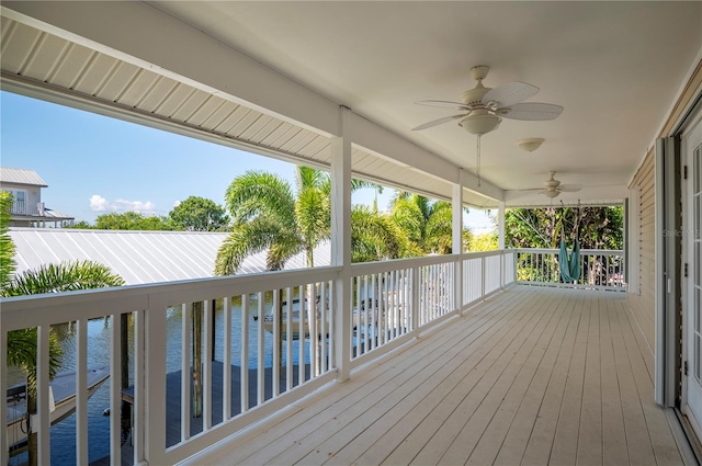 wooden terrace featuring ceiling fan