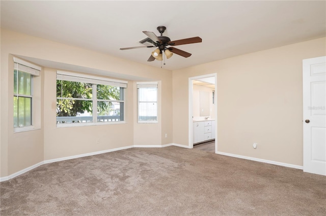 empty room featuring dark carpet and ceiling fan