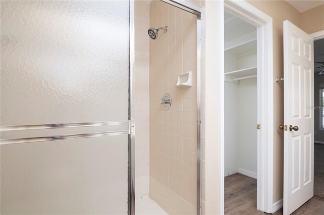 bathroom with walk in shower and hardwood / wood-style flooring