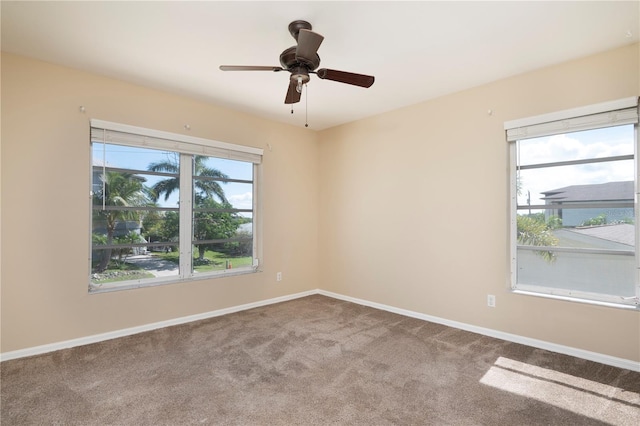 unfurnished room with ceiling fan and a wealth of natural light