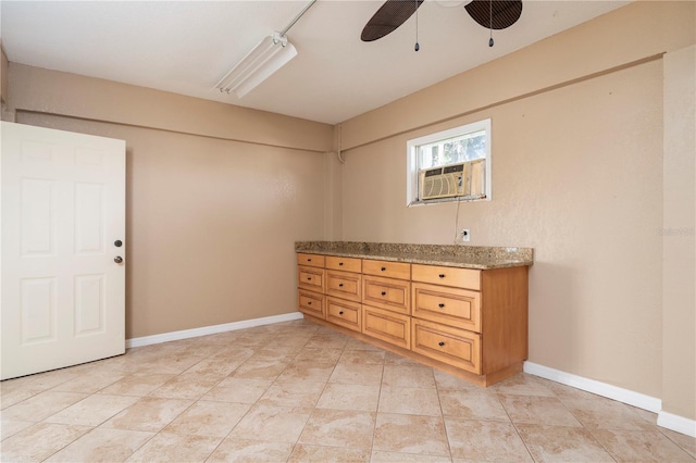 interior space with light tile floors and ceiling fan